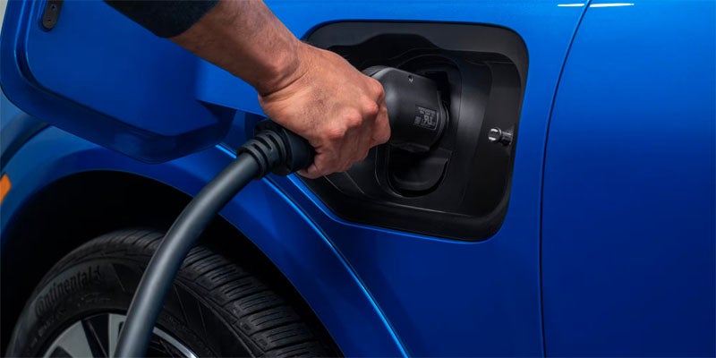 Close up image of person fueling up their Chevrolet Equinox EV- Al Serra Chevrolet in Grand Blanc MI