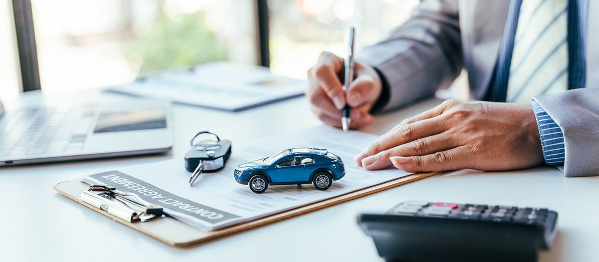Close up image of a customer signing documents - Al Serra Chevrolet in Grand Blanc MI