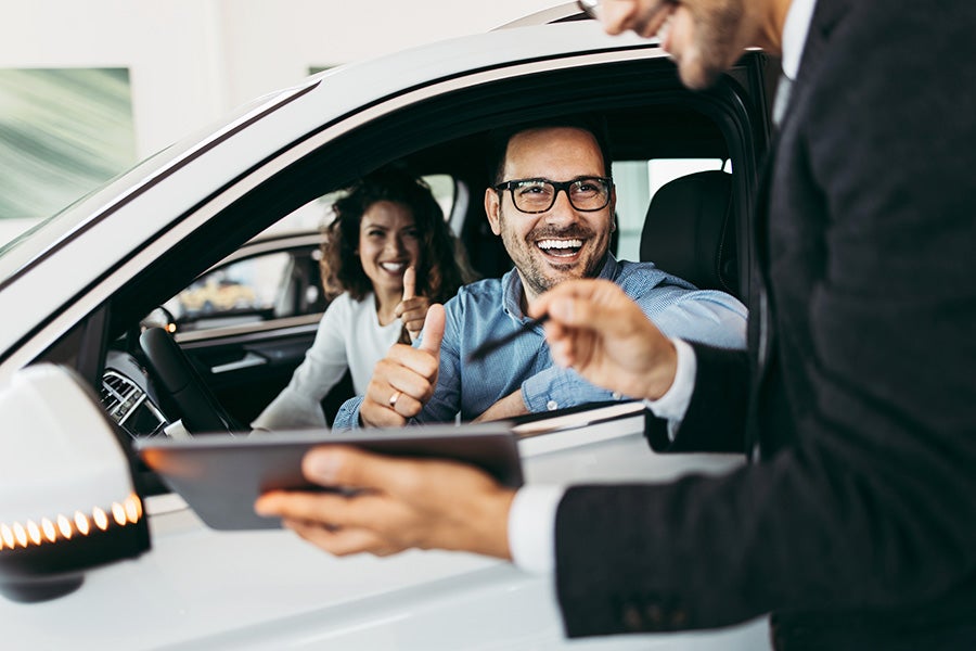 Couple happy to leave in their new car - Al Serra Chevrolet in Grand Blanc MI